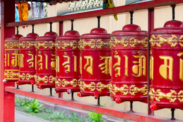 khurde red prayer drums with mantras on the street near the Buddhist temple of the Buryat datsan khurde red prayer drums with mantras on the street near the Buddhist temple of the Russian Buryat datsan close-up selective focus to convey the depth of the image republic of kalmykia stock pictures, royalty-free photos & images