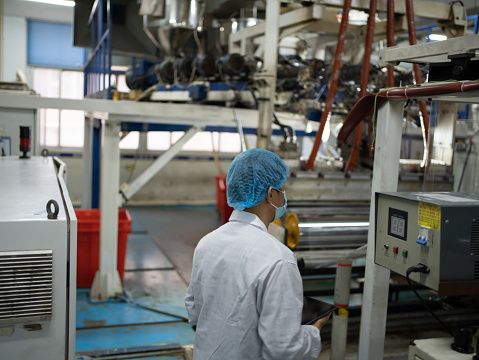 Worker recording data with tablet