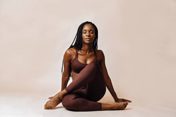 woman in lotus pose yoga studio woman in lotus pose yoga studio portrait yoga stock pictures, royalty-free photos & images