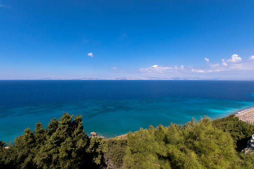 Panoramic view of the turquoise Aegean Sea with plants and hills. In the northwestern part of the Greek island of Rhodes.\nGreece Europe.