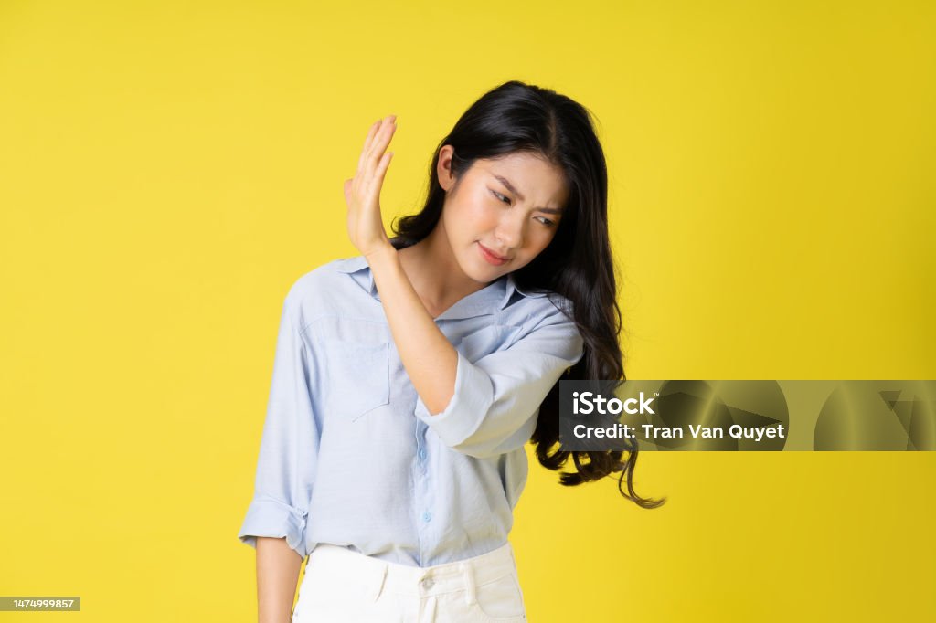 portrait of beautiful asian girl posing on yellow background Beauty Stock Photo