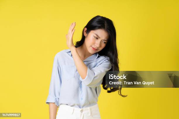Portrait Of Beautiful Asian Girl Posing On Yellow Background Stock Photo - Download Image Now