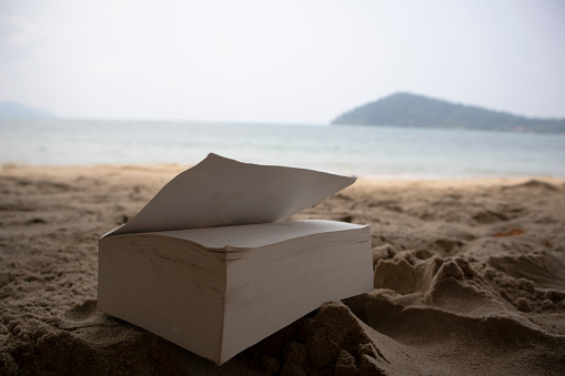 Book on the sand in the beach