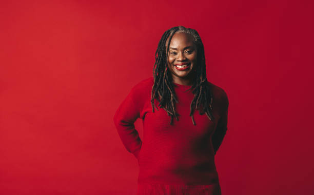 istock Woman with dreadlocks smiling at the camera happily 1475001942