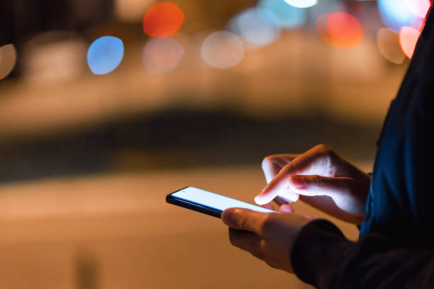istock Using a smartphone in the city at night 1475001947