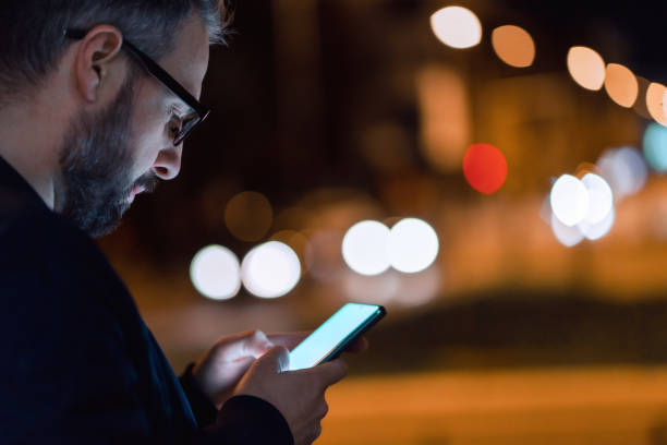 istock Using a smartphone in the city at night 1475001974