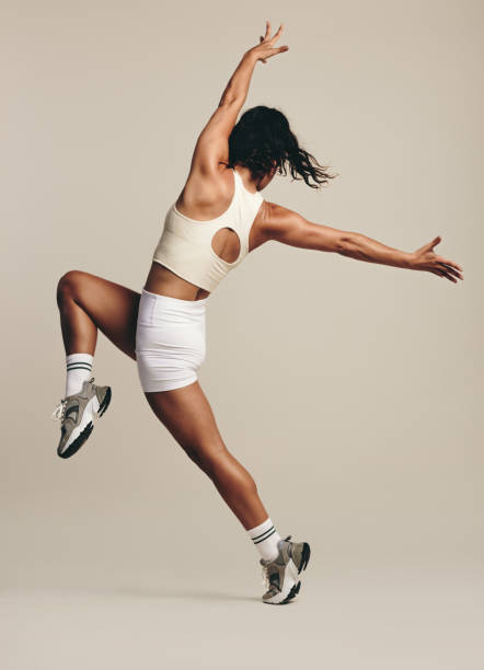 istock Rigorous sport training in the studio: Female athlete doing a full body stretch workout 1475002862