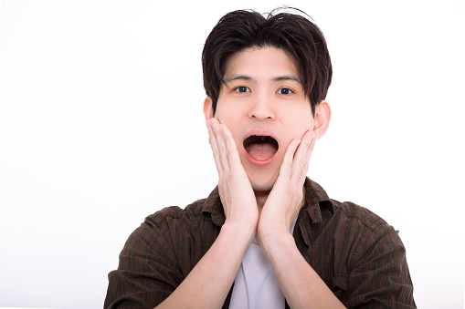 Surprised mature man with his hands over his mouth while isolated on white