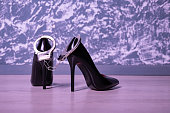 Adult sex games. Kinky lifestyle. Pair of black high-heeled shoes and handcuffs. Bdsm outfit