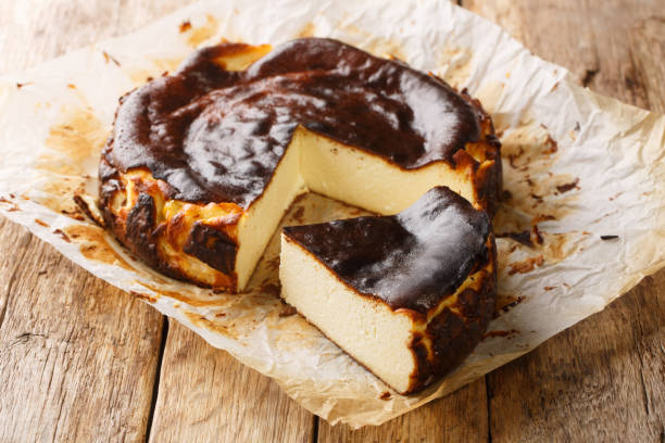 istock Traditional basque burnt cheesecake on a rustic wooden table closeup. Horizontal 1475005503