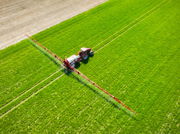istock Tractor with an agriculutural crops sprayer from above 1475007444
