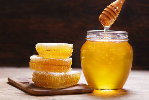 istock jar of honey and honeycombs 1475012459