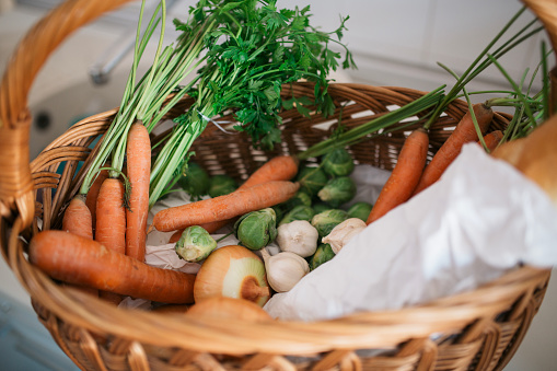 Close up of a basket with different kind of fresh vegetables.