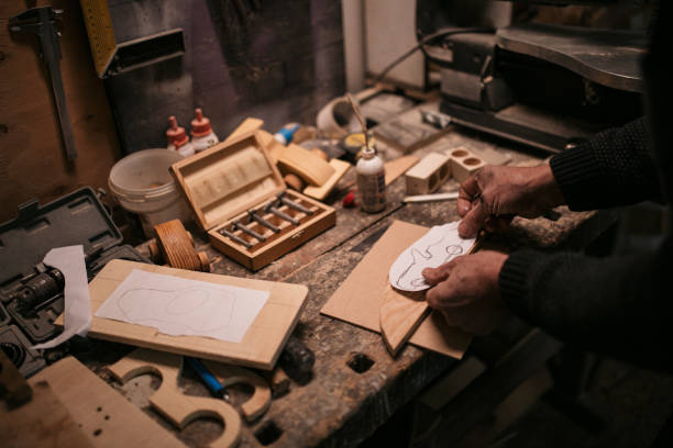 istock Unrecognizable carpenter making wooden toy in a workshop. 1475012779