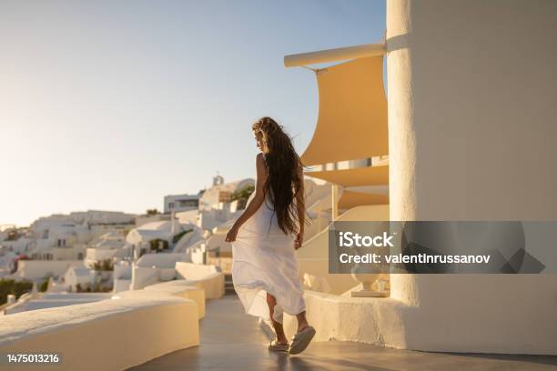 Young Female Asian Woman With White Dress On A Vacation In Santorini Enjoying The View Of The Traditional Architecture Stock Photo - Download Image Now
