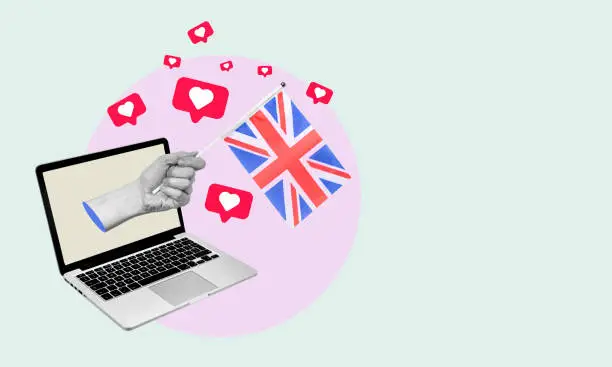 Photo of The art collage is a hand with the UK flag from a laptop with hearts and barks on a light background.
