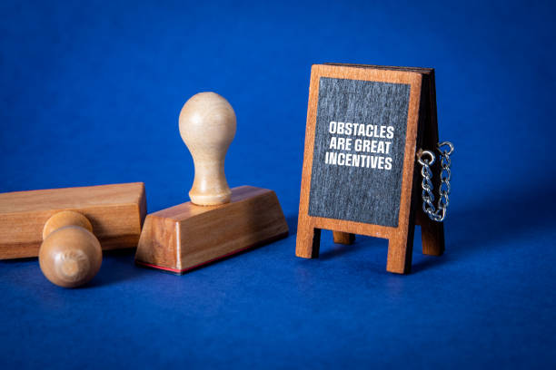 istock Obstacles Are Great Incentives. Miniature chalkboard with text on a blue background 1475014065