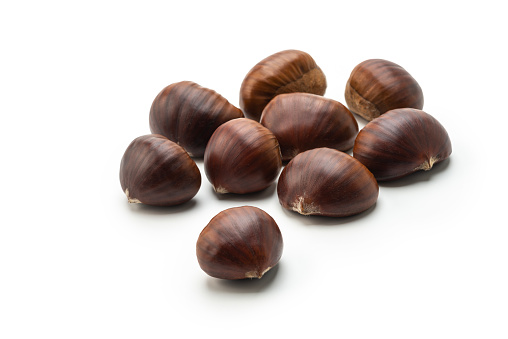Small group of Chestnut with peel on white background, high angle view studio shot.