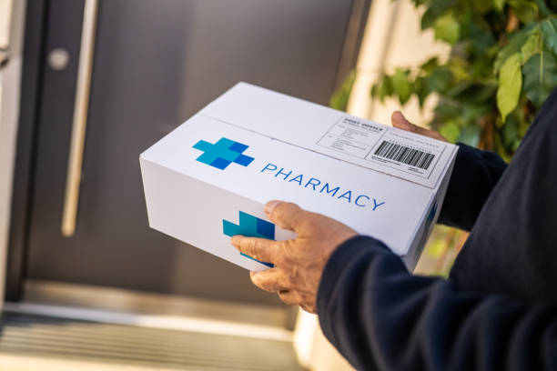 Delivery person holding medicine box