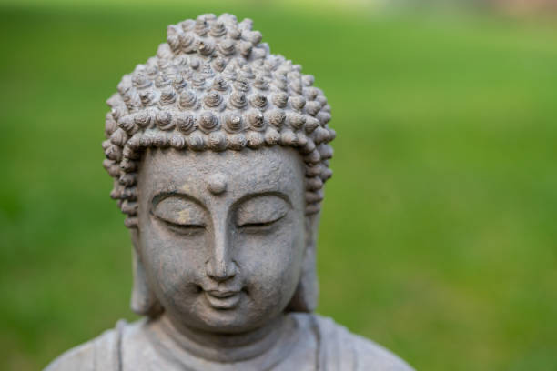 istock buddha statue face in the garden 1475015892