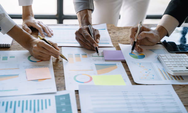 istock Business corporate team brainstorming, planning strategy having a discussion Analysis investment researching with chart at office desk documents in office. 1475016102