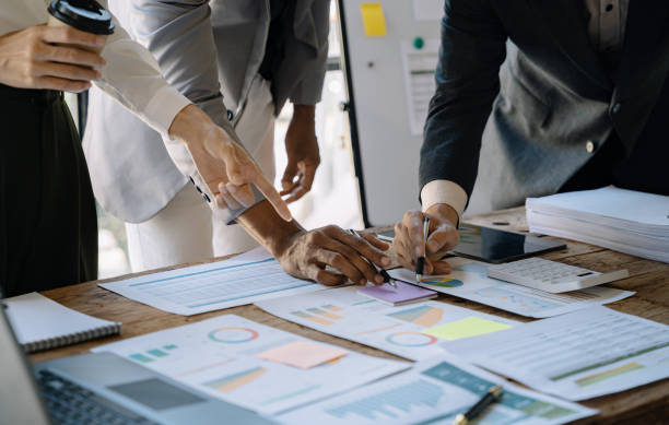 istock Business corporate team brainstorming, planning strategy having a discussion Analysis investment researching with chart at office desk documents in office. 1475016105