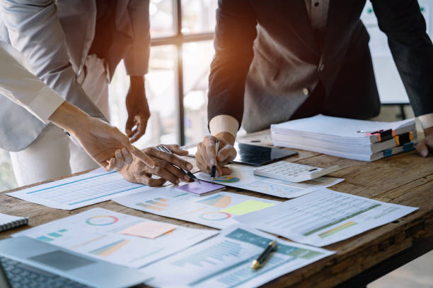 istock Business corporate team brainstorming, planning strategy having a discussion Analysis investment researching with chart at office desk documents in office. 1475016110