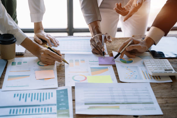 istock Business corporate team brainstorming, planning strategy having a discussion Analysis investment researching with chart at office desk documents in office. 1475016111