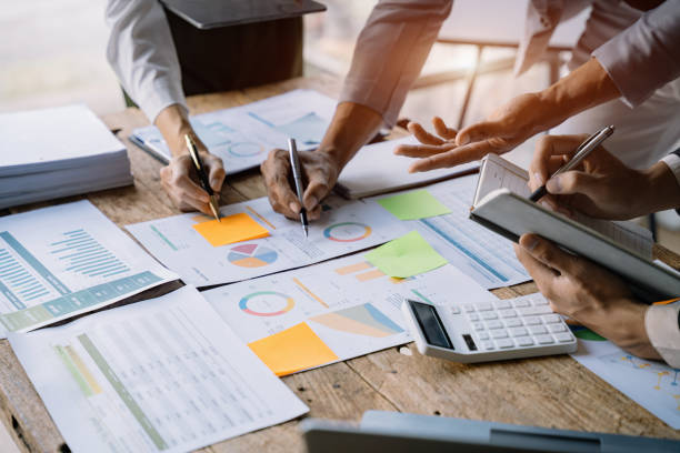 istock Business corporate team brainstorming, planning strategy having a discussion Analysis investment researching with chart at office desk documents in office. 1475016114