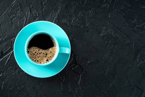 istock Coffee cup, shot from above on a black stone background with a place for text 1475018765