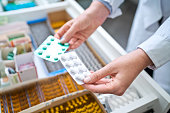 Female pharmacist holding medicines
