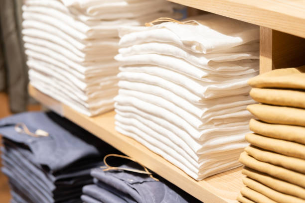 istock Stack of cotton colorful clothes on table in cloth store. 1475020393