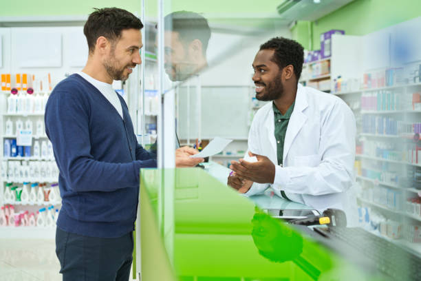istock Male pharmacist and customer in pharmacy 1475020859