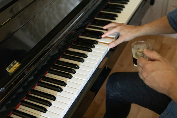 istock Young man take a coffee and composes a piano song 1475022241