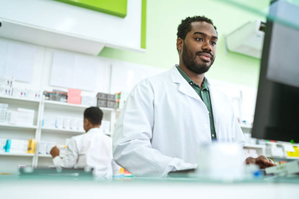 Male pharmacist in pharmacy stock photo