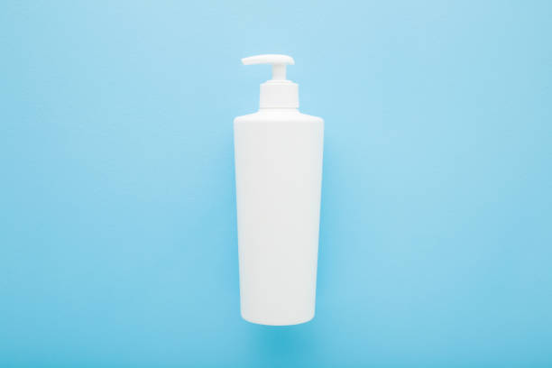istock White big plastic pump bottle on light blue table background. Pastel color. Care about clean and soft body skin. Daily beauty product. Closeup. Empty place for text or logo. Top down view. 1475022850