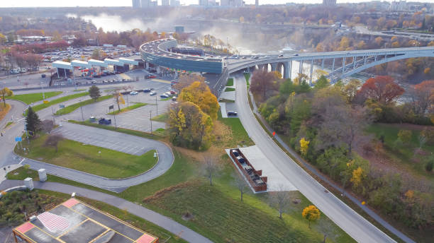 istock Rainbow international bridge border crossing checkpoint near Niagara Falls with splashes water between New York, USA and Ontario, Canada 1475022991