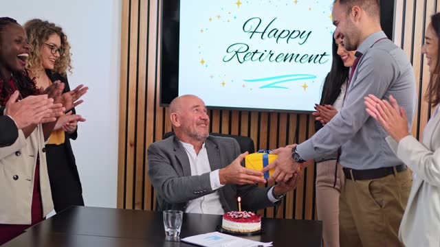 Group Of People Having A Retirement Party For Their Colleague At The Office