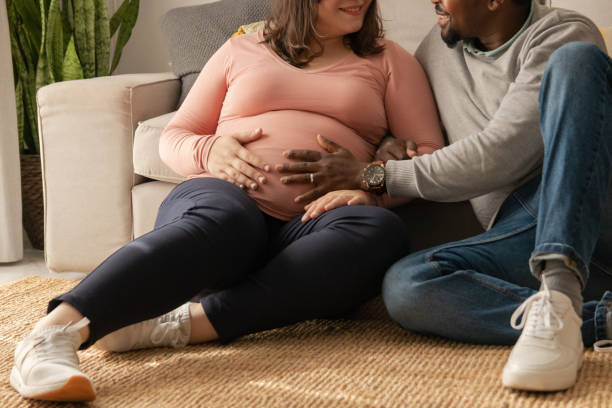 istock Multi ethnic couple touch pregnant woman's belly 1475024721