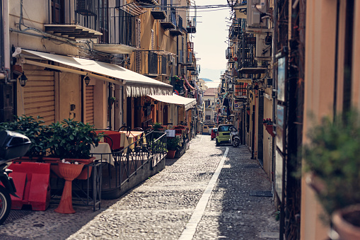Beautiful narrow street in Italian town of Cefalu, Sicily. Sunny, off-season, Spring day in Italy, Sicily. 
Canon R5