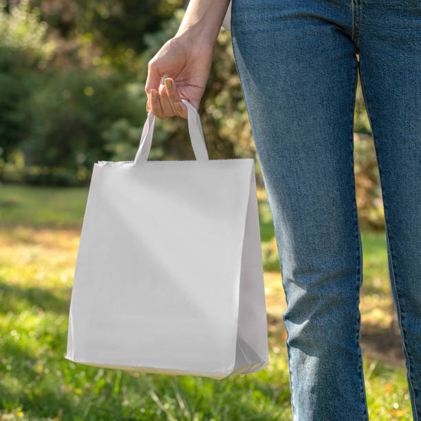 istock hand holding a white blank shopping bag 1475028198