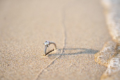Diamond rings on the sand. And they are wedding rings. backgrounds textures