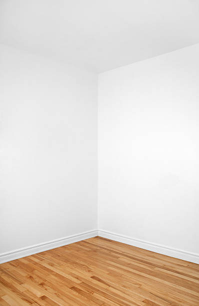 Empty corner of a room with wooden floor stock photo