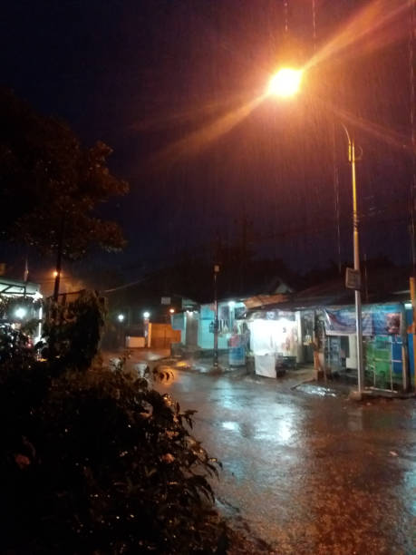 istock Raindrops illuminated in neon street light at night 1475030103