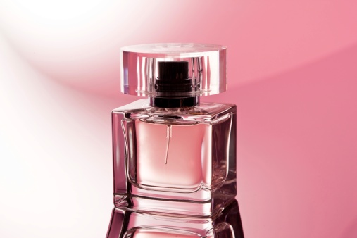Women's perfume and spring apple blossom branch. Female romantic perfumes.