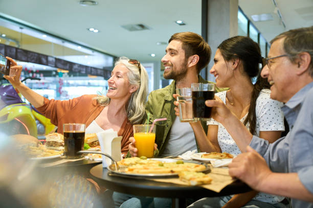 istock Two generation family taking a selfie while having lunch 1475032480