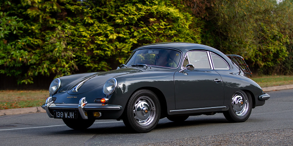 Whittlebury,Northants,UK - August 26th 2022. 1960 grey Porsche 356B coupe driving on an English country road