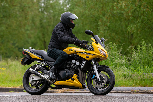 Stony Stratford, Bucks, UK. June 5th 2022. Yellow Yamaha Fazer motorcycle on a rainy day