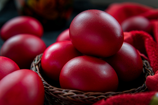 A basket full of Easter eggs dyed in traditional red colour.