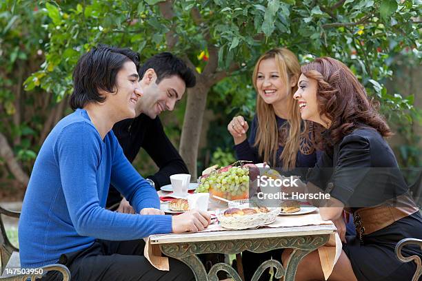 Young Friends Enjoying Coffee At A Restaurant Stock Photo - Download Image Now - Coffee - Drink, Outdoors, People